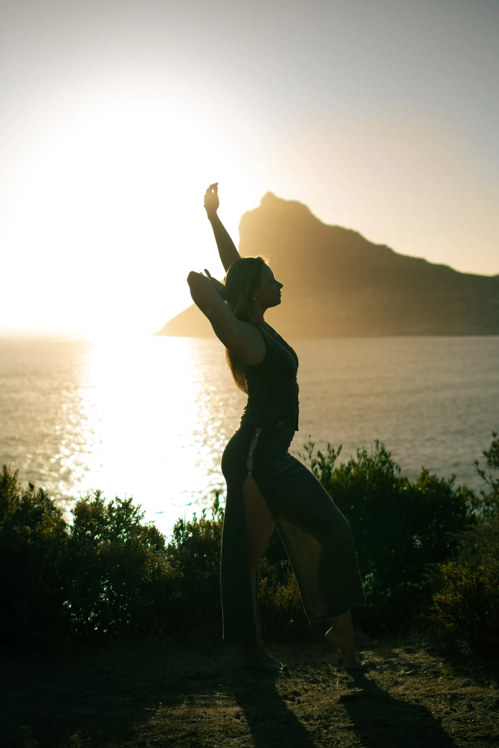 Madison reaching toward the sunset, silhouette on the beach