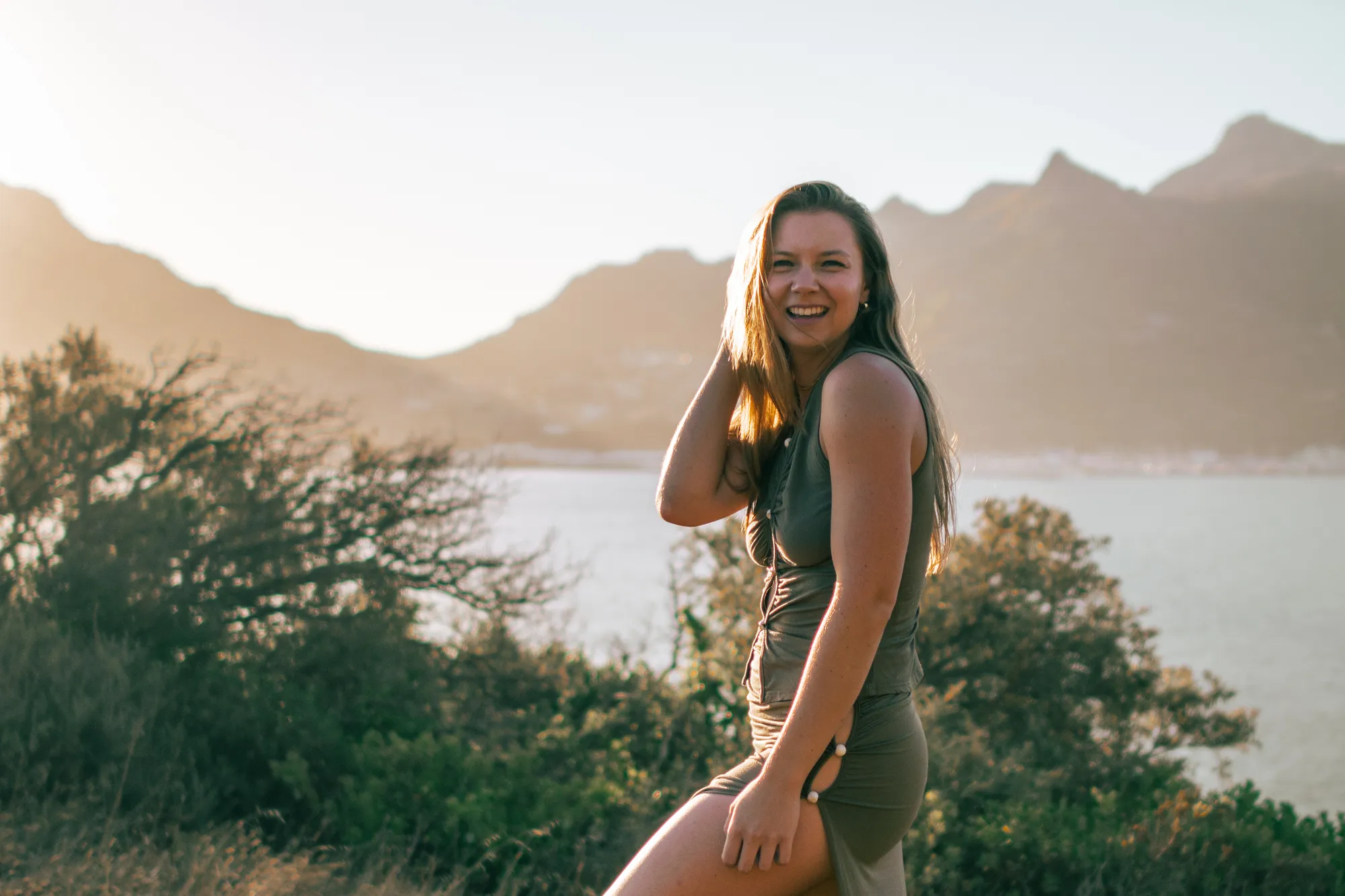 Madison in a casual pose with the ocean behind her