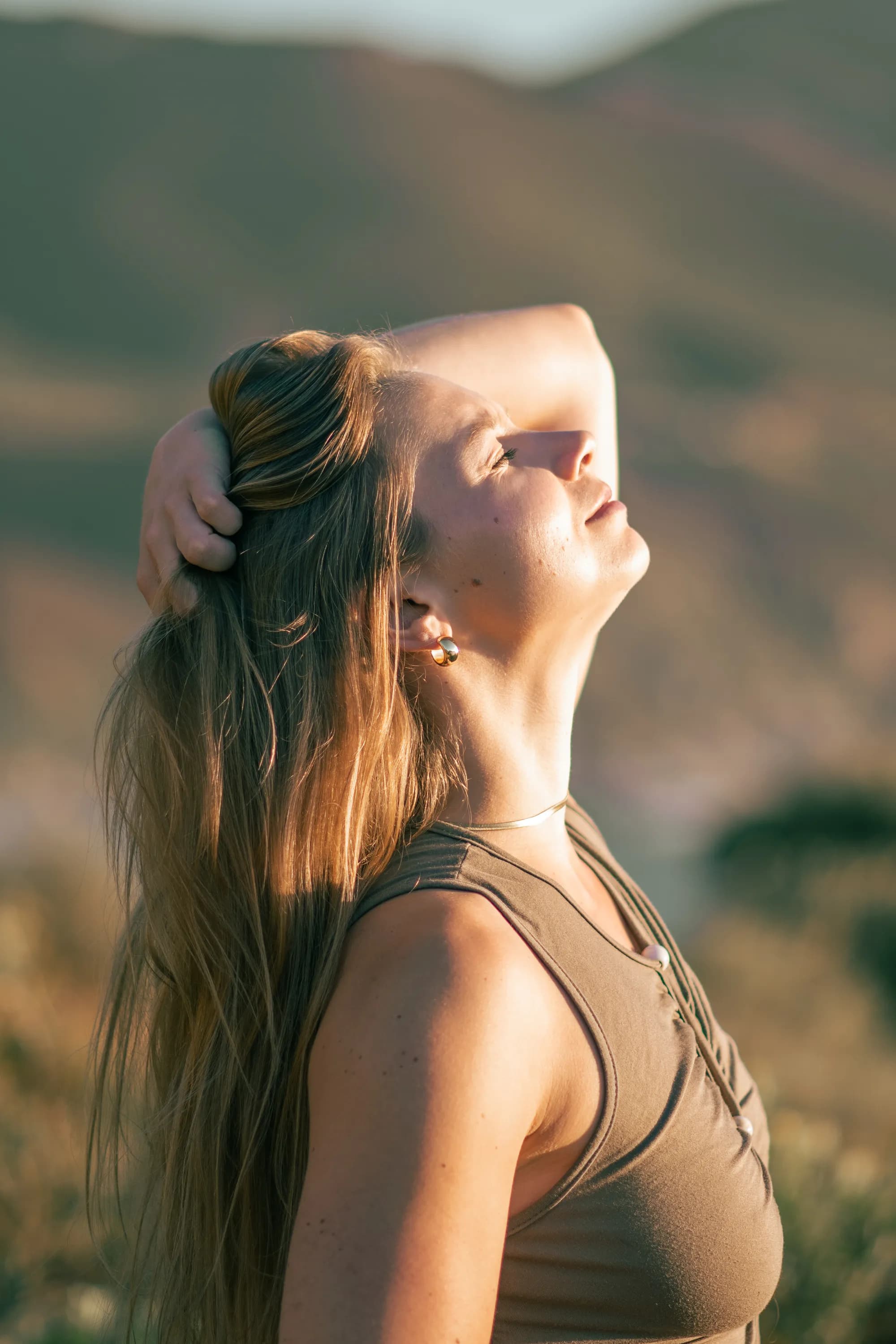 Madison close-up, eyes closed, peaceful in golden light
